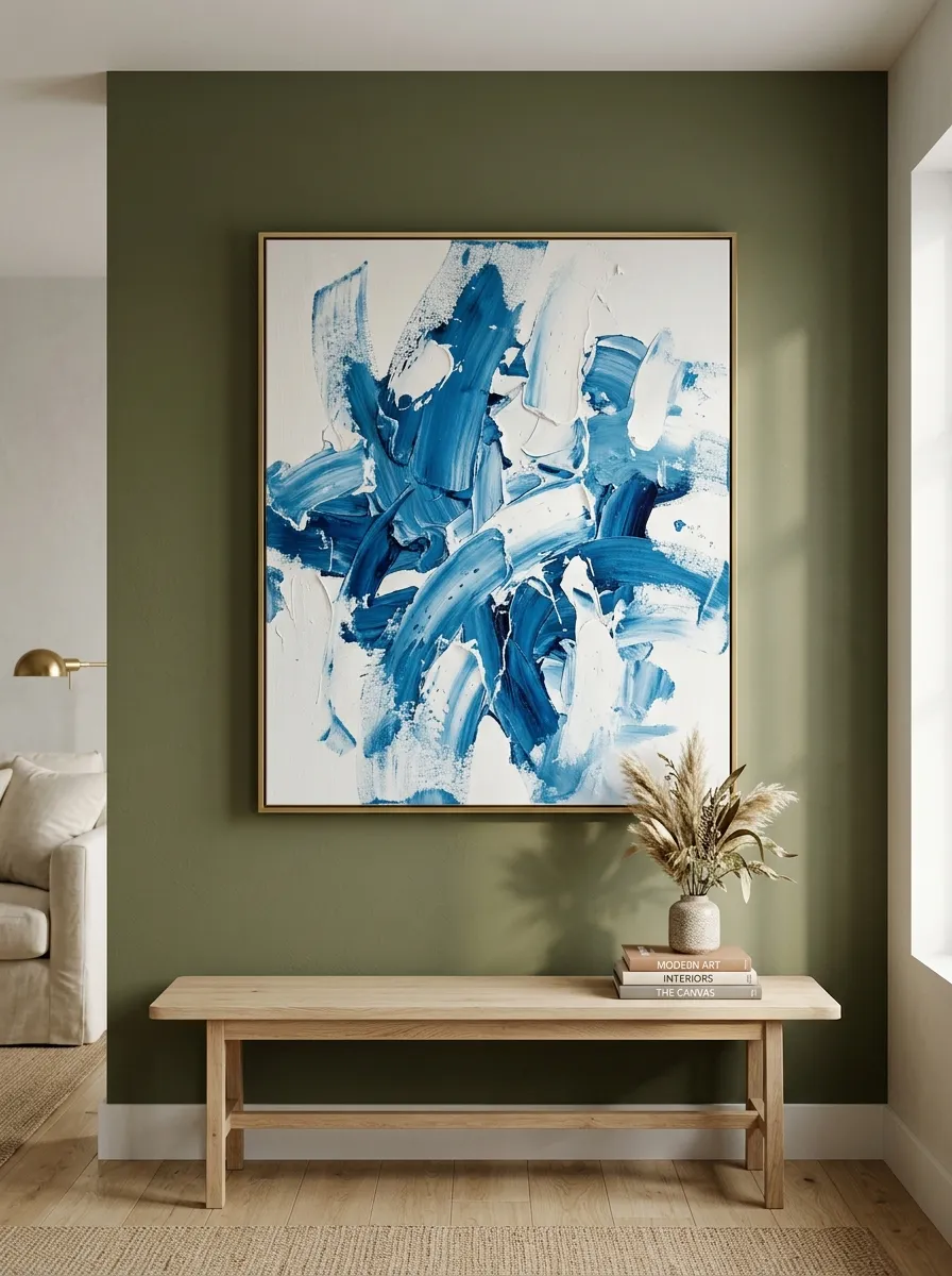 Living room wall painted in muted olive green featuring a large abstract cerulean blue oil painting