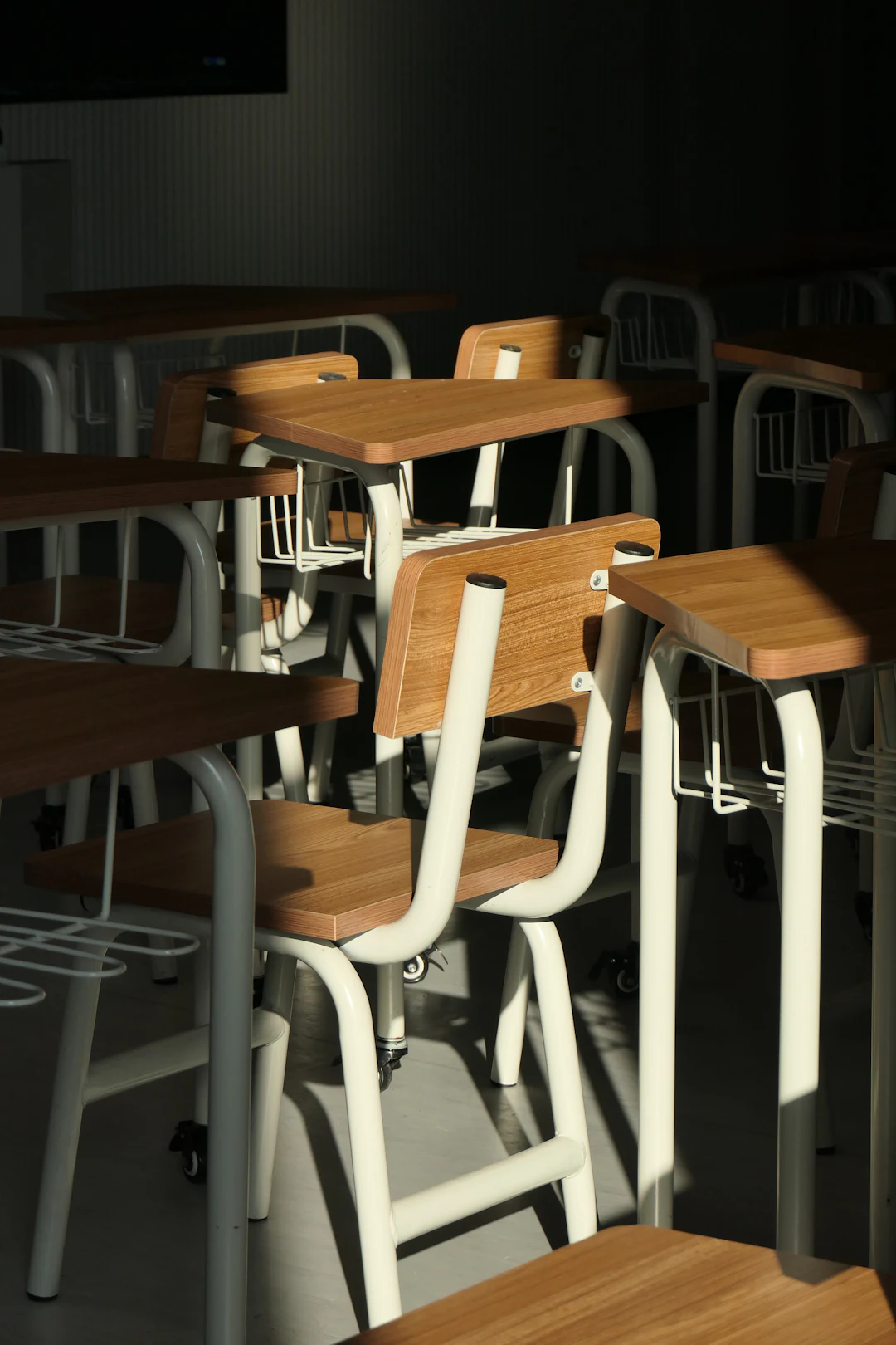 Warm daylight on orderly desks in a calm classroom